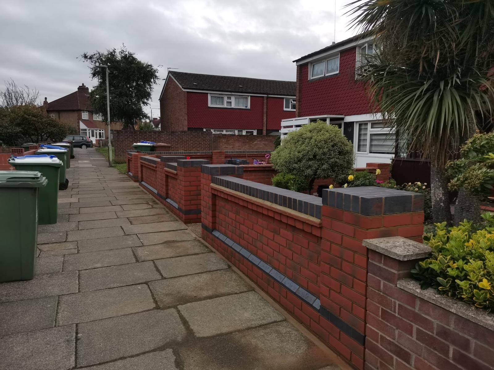 Completed red brick boundary walls with contrasting brick detailing