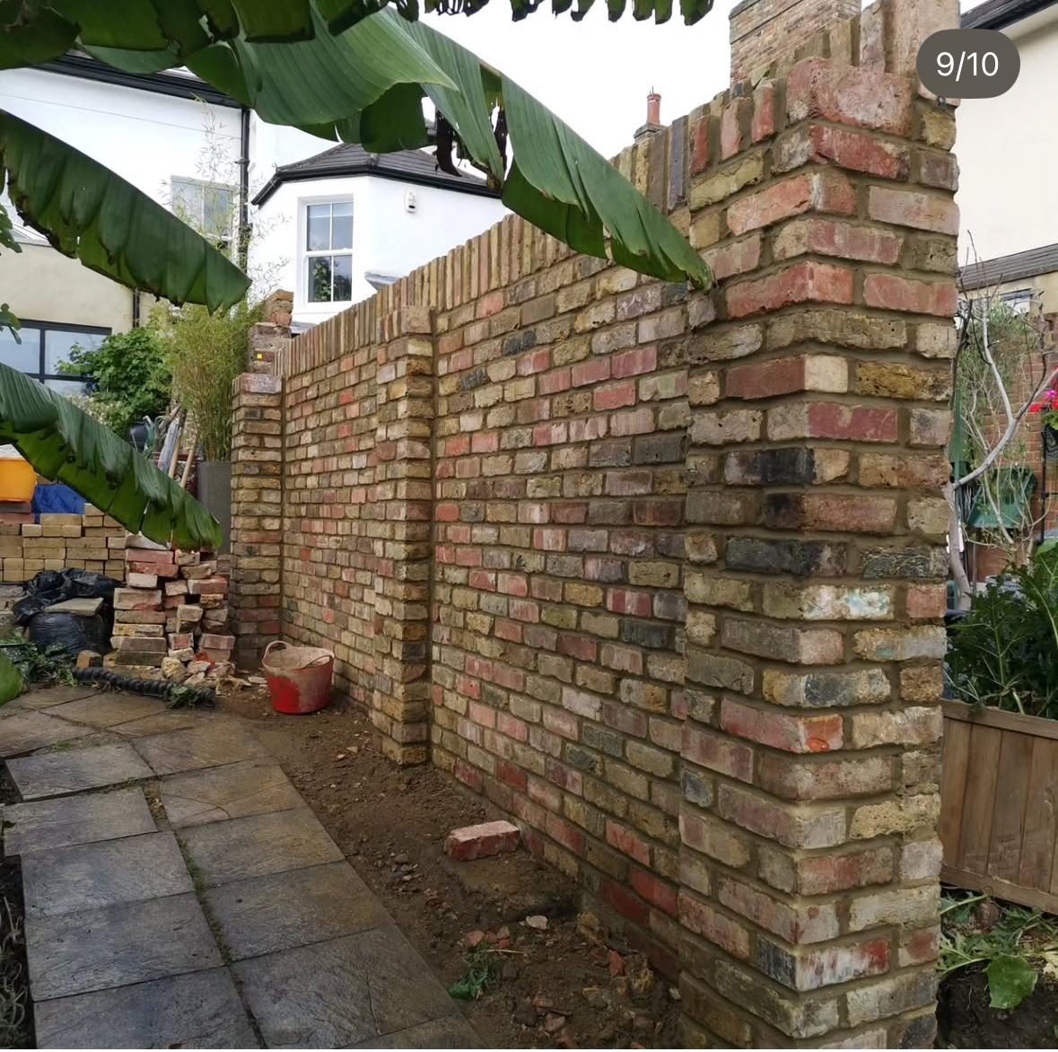 Garden brick wall built with reclaimed style bricks and detailed brick pier