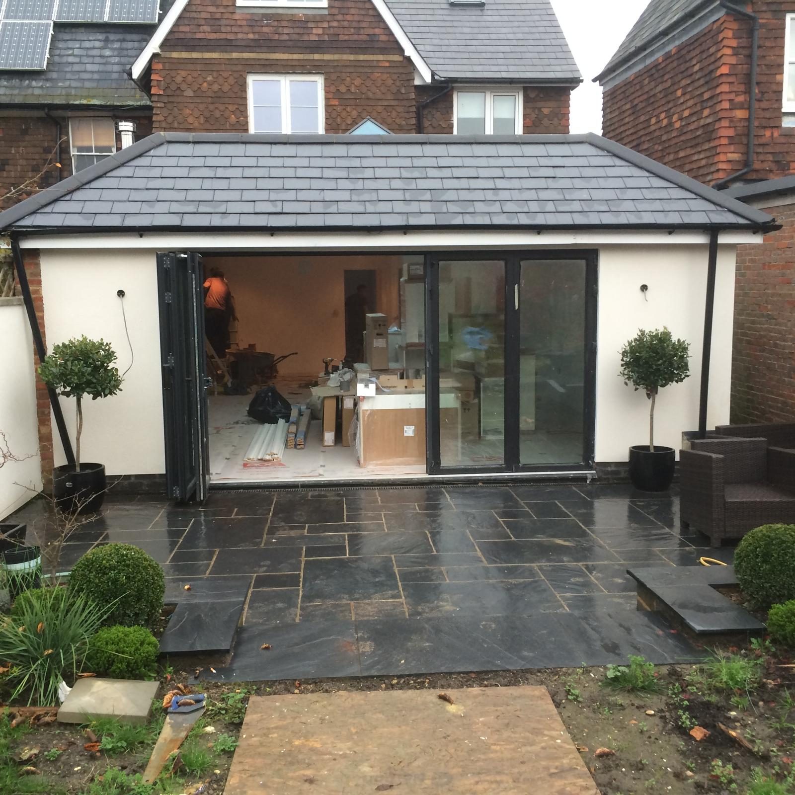 Completed slate style roof to rear extension with paved terrace